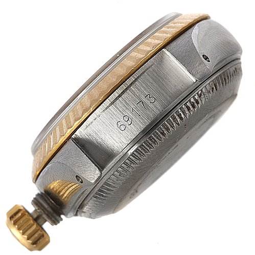 This image shows the side view of the Rolex Datejust 69173 Women's Yellow Gold Champagne Dial 69173 Women's Yellow Gold Champagne Dial watch case, highlighting the bezel, crown, and engraved serial number.