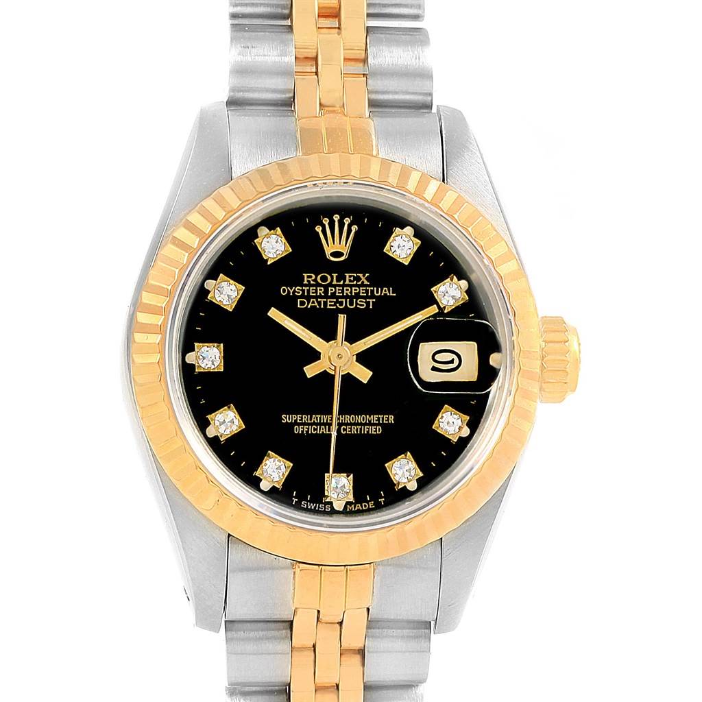 The image shows a close-up of a Rolex Datejust 69173 Women's Stainless Steel Black Dial 69173 Women's Stainless Steel Black Dial watch face and partial bracelet, highlighting the black dial, diamond hour markers, and gold fluted bezel.