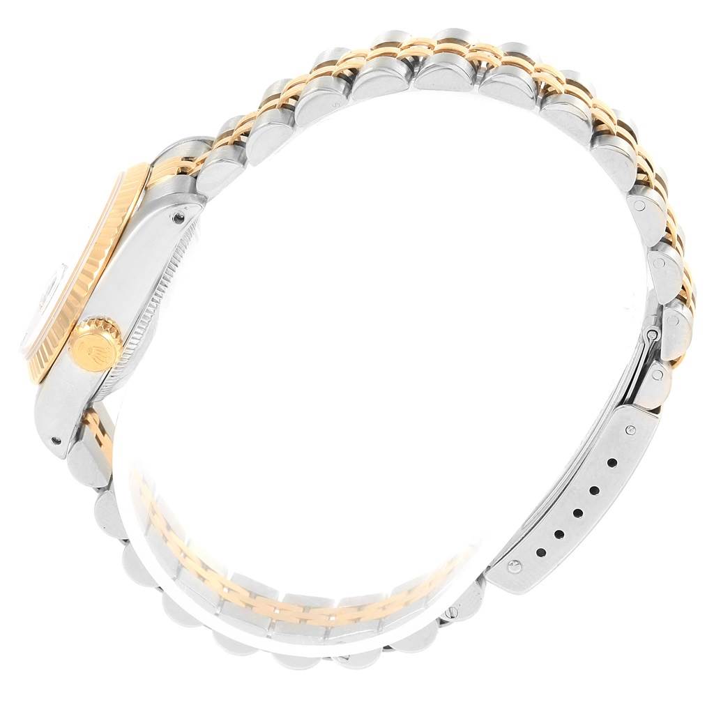 This side view of the Rolex Datejust 69173 Women's Stainless Steel Black Dial 69173 Women's Stainless Steel Black Dial watch shows the two-tone bracelet, crown, and case partially.