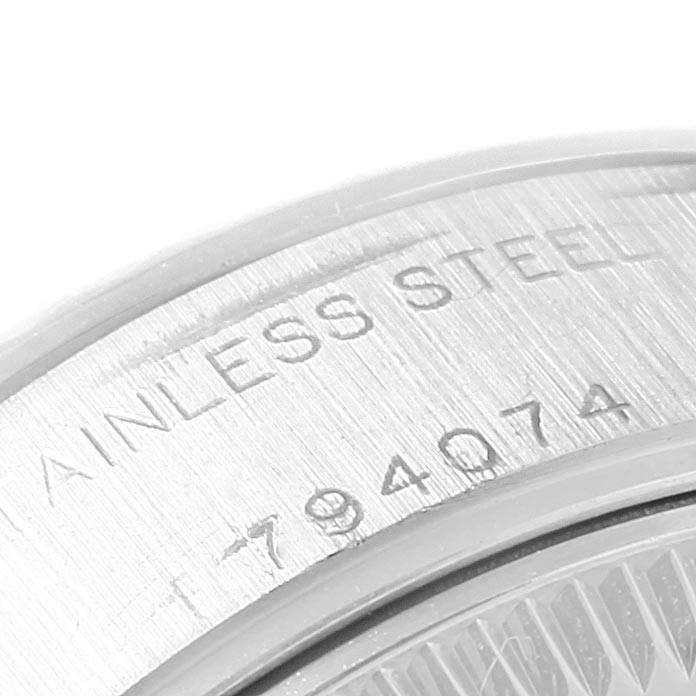 The image shows a close-up of the back casing of a Rolex Datejust 79174 Women's Stainless Steel Mother of Pearl Dial 79174 Women's Stainless Steel Mother of Pearl Dial watch, highlighting the serial number and material (stainless steel).