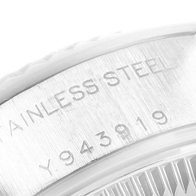 This image shows a close-up of the engraved side with the serial number and "Stainless Steel" text of a Rolex Datejust 79174 Women's Stainless Steel Blue Dial 79174 Women's Stainless Steel Blue Dial watch.