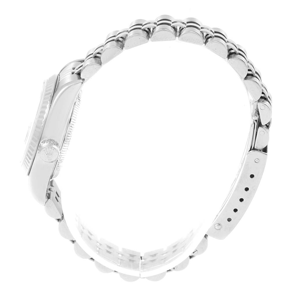 The image shows a side view of a Rolex Datejust 79174 Women's Stainless Steel Blue Dial 79174 Women's Stainless Steel Blue Dial watch, focusing on the case, crown, and stainless steel bracelet.