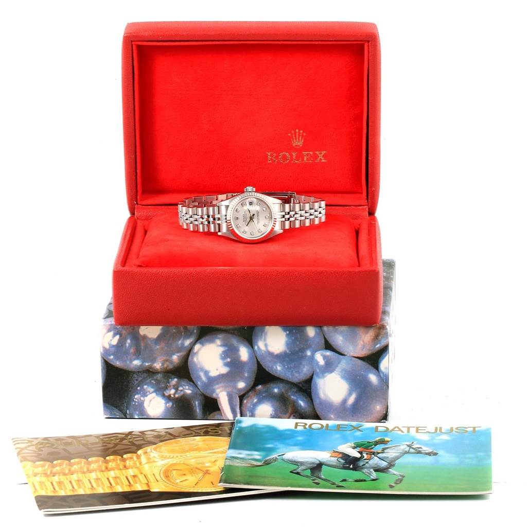 The image shows a Rolex Datejust 79174 Women
s Stainless Steel Silver Dial 79174 Women
s Stainless Steel Silver Dial watch in its open red box, with additional booklets below.
