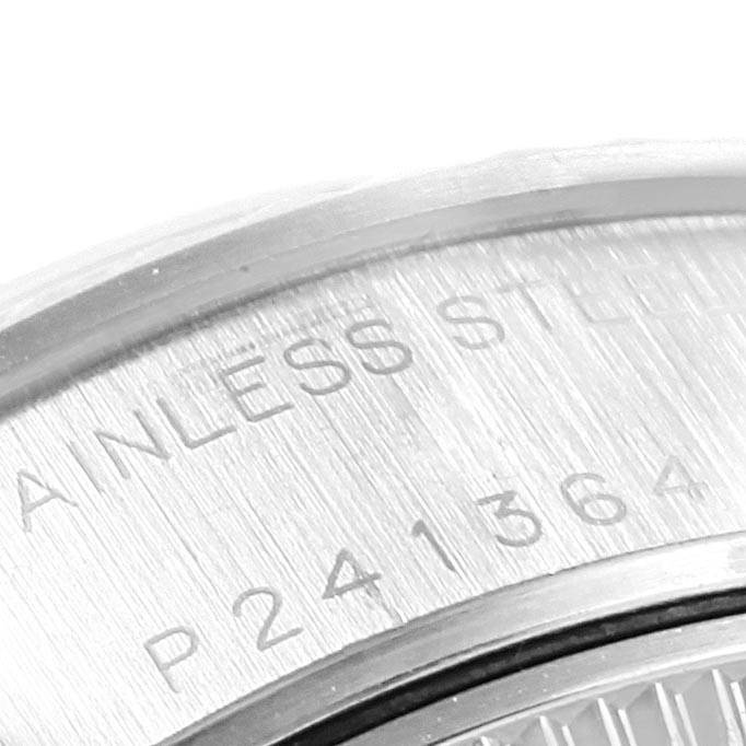 The image shows a close-up of the back casing of a Rolex Datejust 79174 Women
s Stainless Steel Silver Dial 79174 Women
s Stainless Steel Silver Dial watch, highlighting the etched serial number and stainless steel engraving.