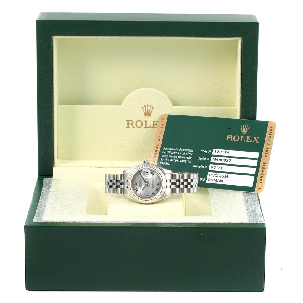 The Rolex Datejust 179174 Women
s Stainless Steel Silver Dial 179174 Women
s Stainless Steel Silver Dial watch is displayed front-on in its open green box with its certification card.