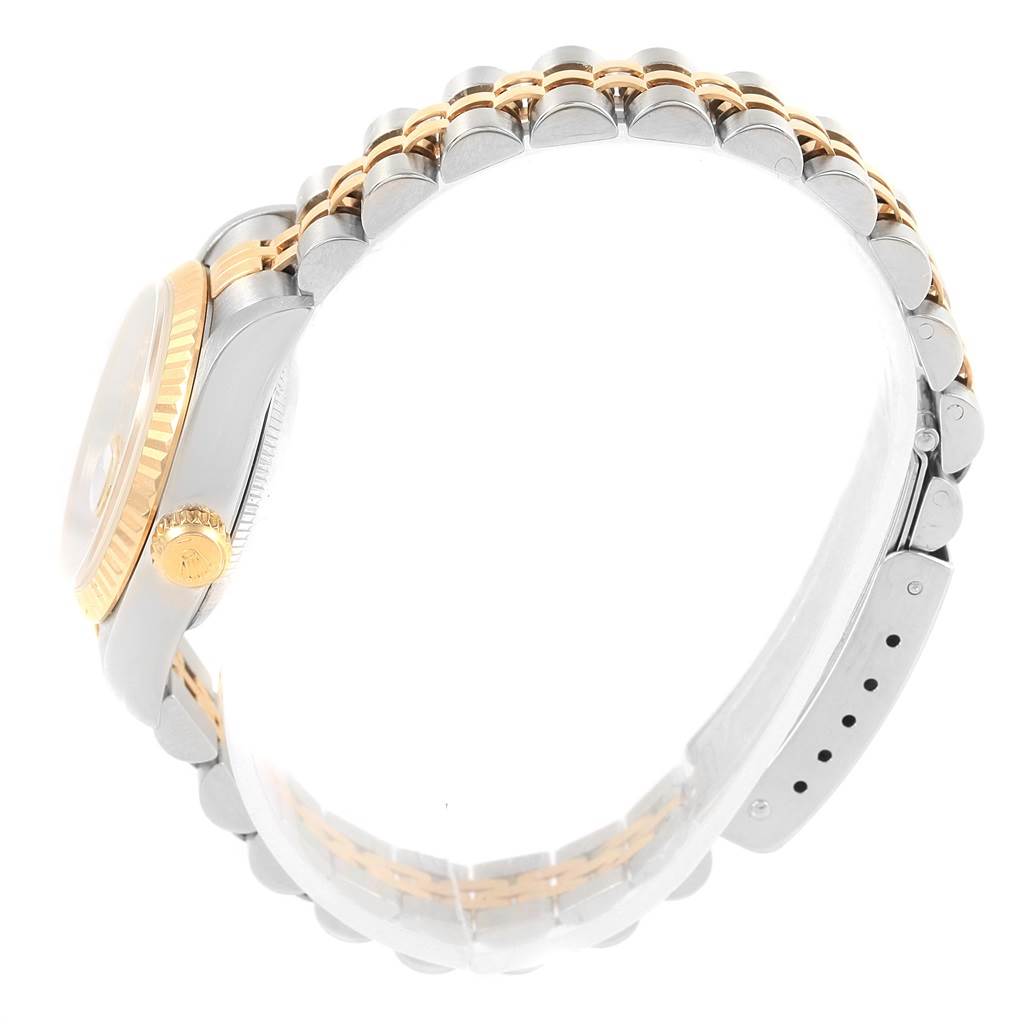 This image shows a side view of the Rolex Datejust 69173 Women
s Stainless Steel Champagne Dial 69173 Women
s Stainless Steel Champagne Dial, focusing on the watch band and the gold crown on the side.