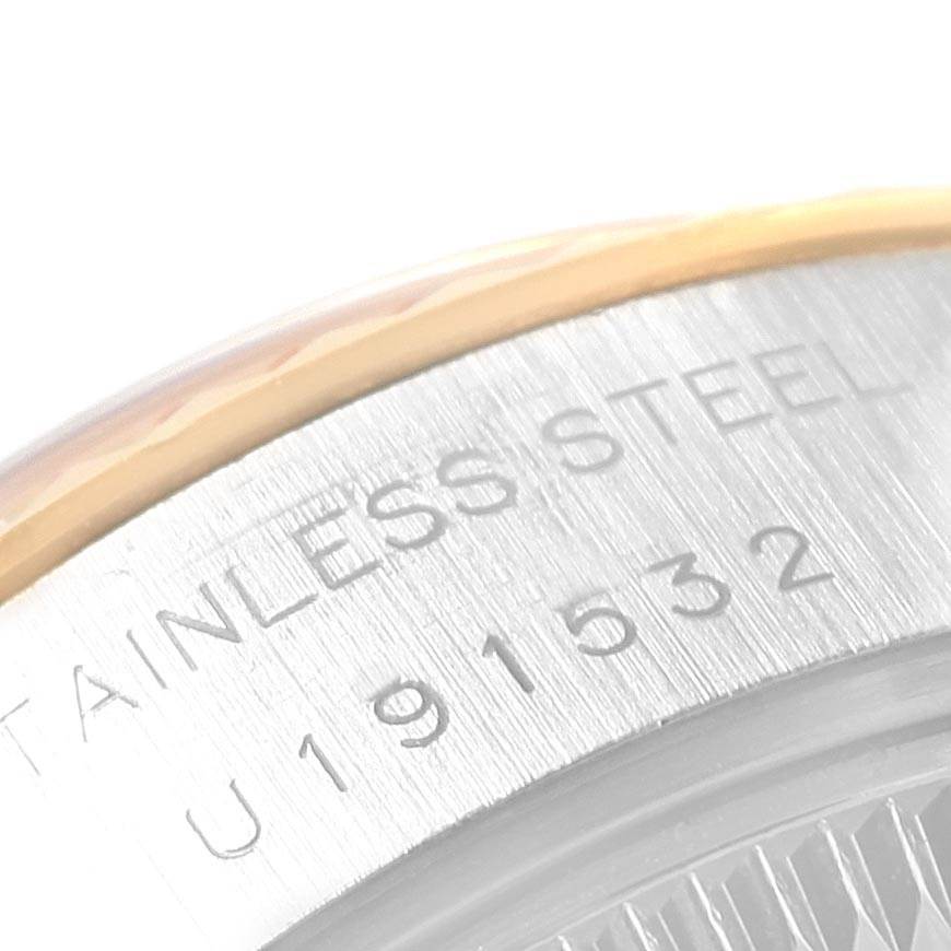 This close-up angle shows the engraved serial number and "STAINLESS STEEL" text on the side of a Rolex Datejust 69173 Women
s Stainless Steel Champagne Dial 69173 Women
s Stainless Steel Champagne Dial watch case.