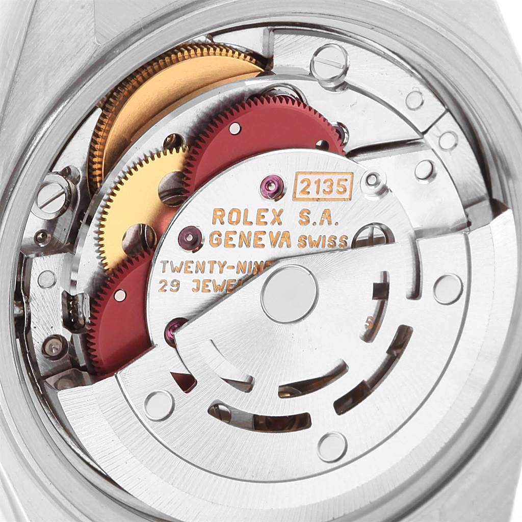The image shows the internal mechanism of a Rolex Datejust 69173 Women
s Stainless Steel Champagne Dial 69173 Women
s Stainless Steel Champagne Dial watch, highlighting the gears and movement components.