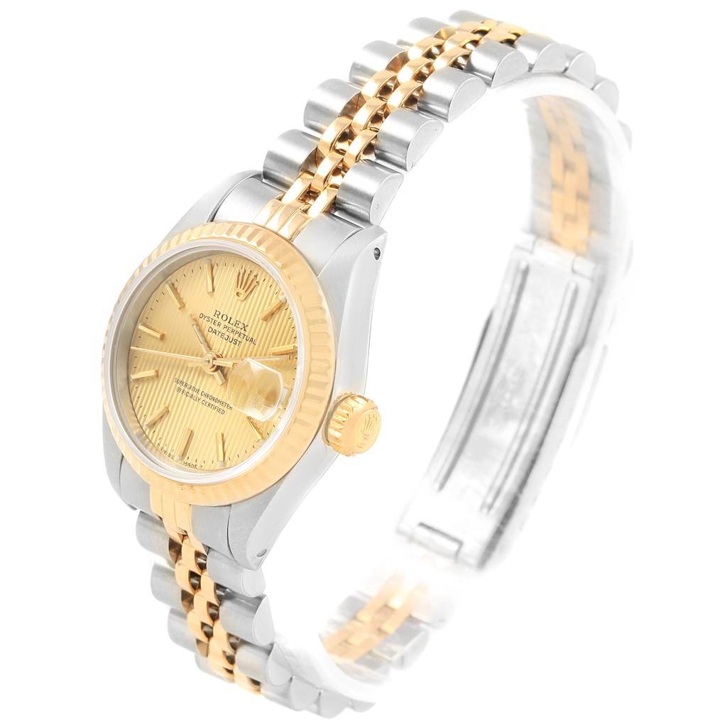 The Rolex Datejust 69173 Women's Stainless Steel Champagne Dial 69173 Women's Stainless Steel Champagne Dial watch is shown from a side-angle, highlighting its golden dial, fluted bezel, and Jubilee bracelet.