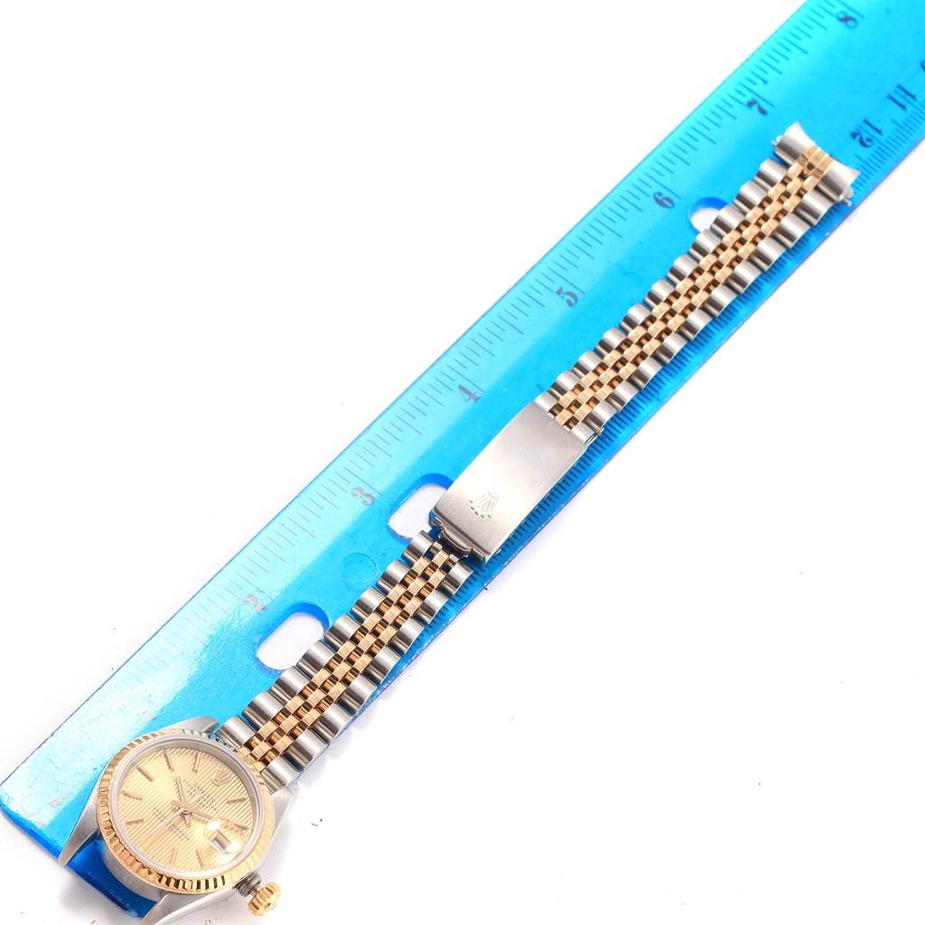 The image shows a Rolex Datejust 69173 Women's Stainless Steel Champagne Dial 69173 Women's Stainless Steel Champagne Dial watch lying flat against a blue ruler, displaying its face and bracelet.