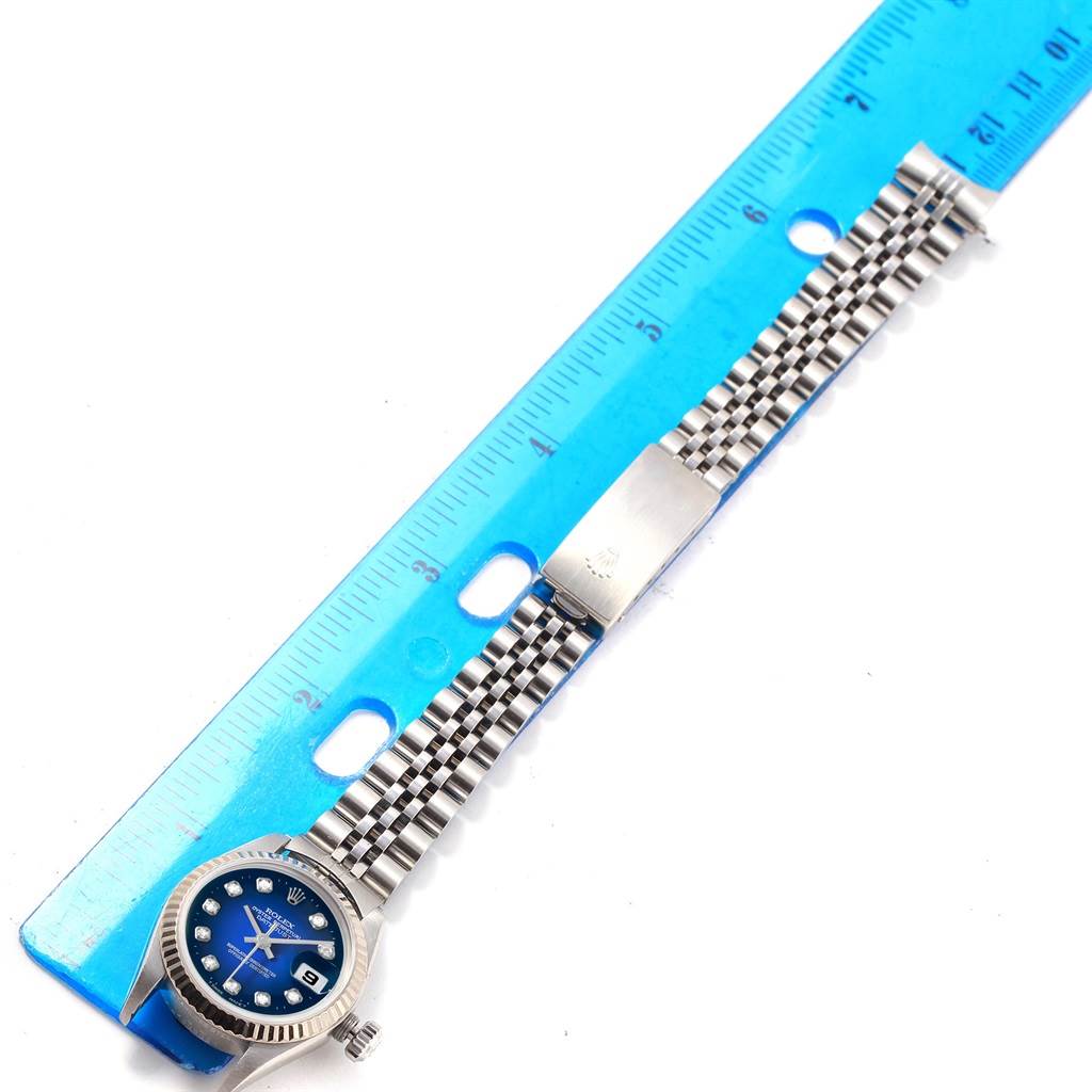 The image shows a Rolex 79174 Men's Stainless Steel Blue Dial 79174 Men's Stainless Steel Blue Dial Datejust Steel White Gold Blue Diamond Dial Ladies Watch, model 79174, lying flat next to a ruler.