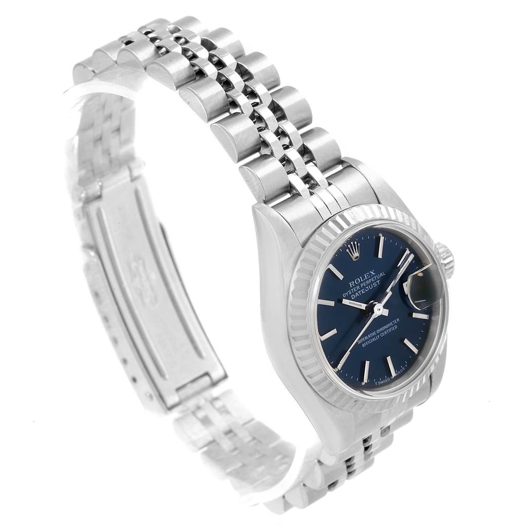 The image shows a side view of a Rolex Datejust 79174 Women
s Stainless Steel Blue Dial 79174 Women
s Stainless Steel Blue Dial watch, highlighting its bracelet, clasp, bezel, dial, and crown.