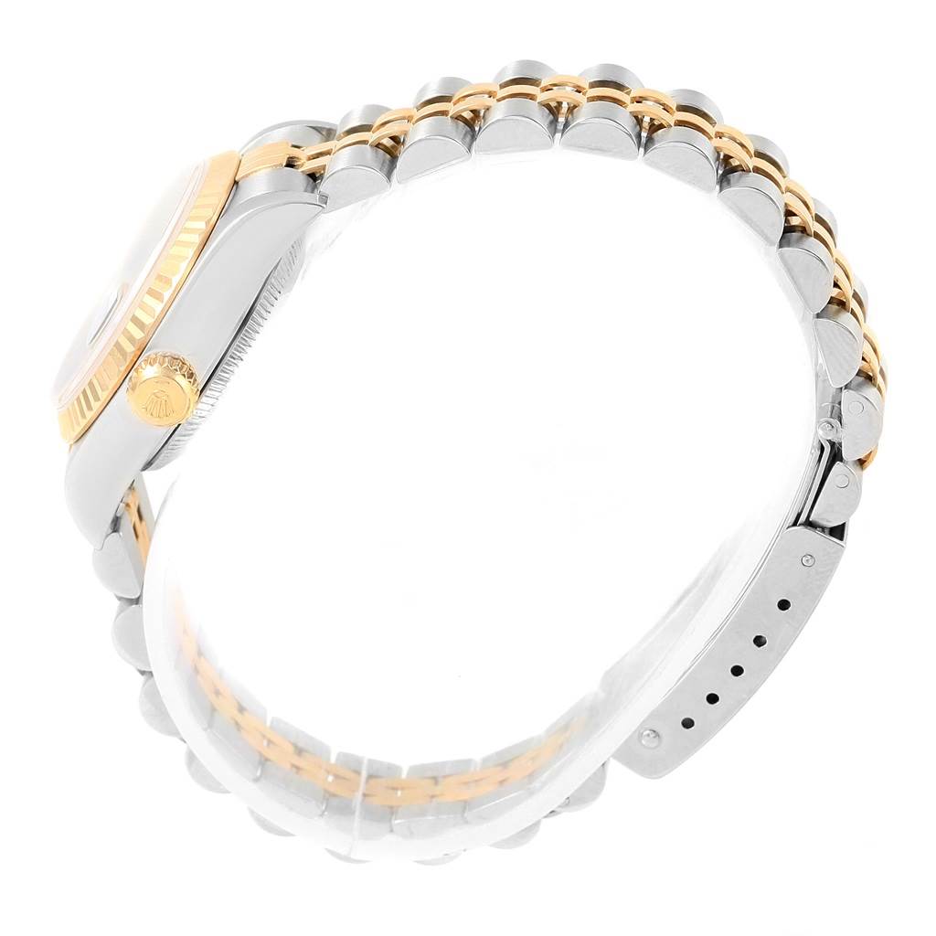 The image shows the side view of a Rolex Datejust 79173 Women's Stainless Steel Champagne Dial 79173 Women's Stainless Steel Champagne Dial, highlighting its fluted bezel, crown, and two-tone metal bracelet.