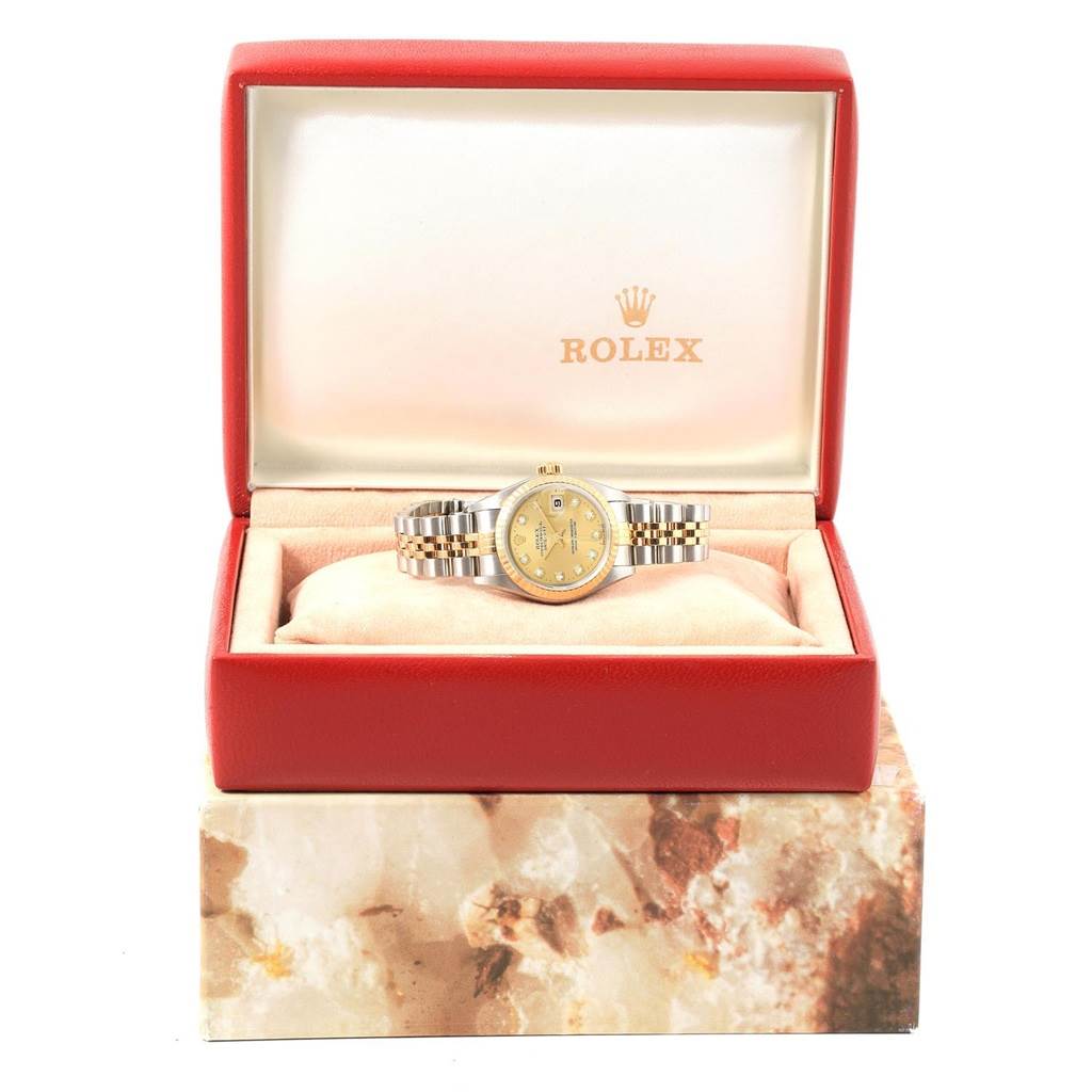 The Rolex Datejust 79173 Women's Stainless Steel Champagne Dial 79173 Women's Stainless Steel Champagne Dial watch is displayed front-on, resting in an open red box with both the watch face and bracelet visible.