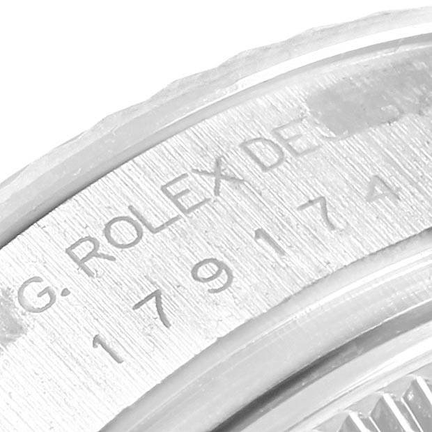 This image shows a close-up of the engraved serial number on the caseback rim of a Rolex Datejust 179174 Women's Stainless Steel Silver Dial 179174 Women's Stainless Steel Silver Dial watch.