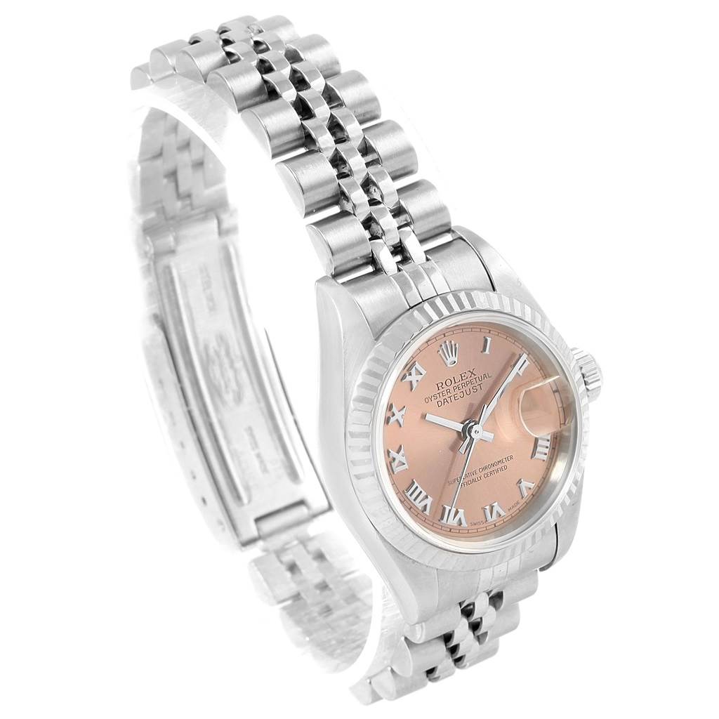 This image shows a Rolex Datejust 79174 Women
s Stainless Steel Pink Dial 79174 Women
s Stainless Steel Pink Dial watch at an angled view, highlighting its dial, bezel, and part of the bracelet.