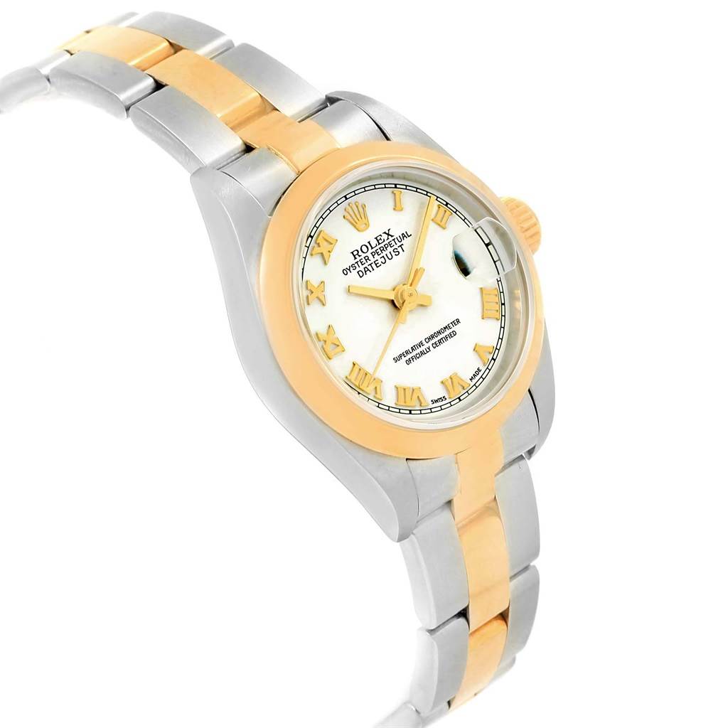 The Rolex Datejust 79163 Women's Steel and Gold (two tone) White Dial 79163 Women's Steel and Gold (two tone) White Dial watch is shown at a slanted angle, showcasing its dial, bezel, crown, and part of the bracelet.