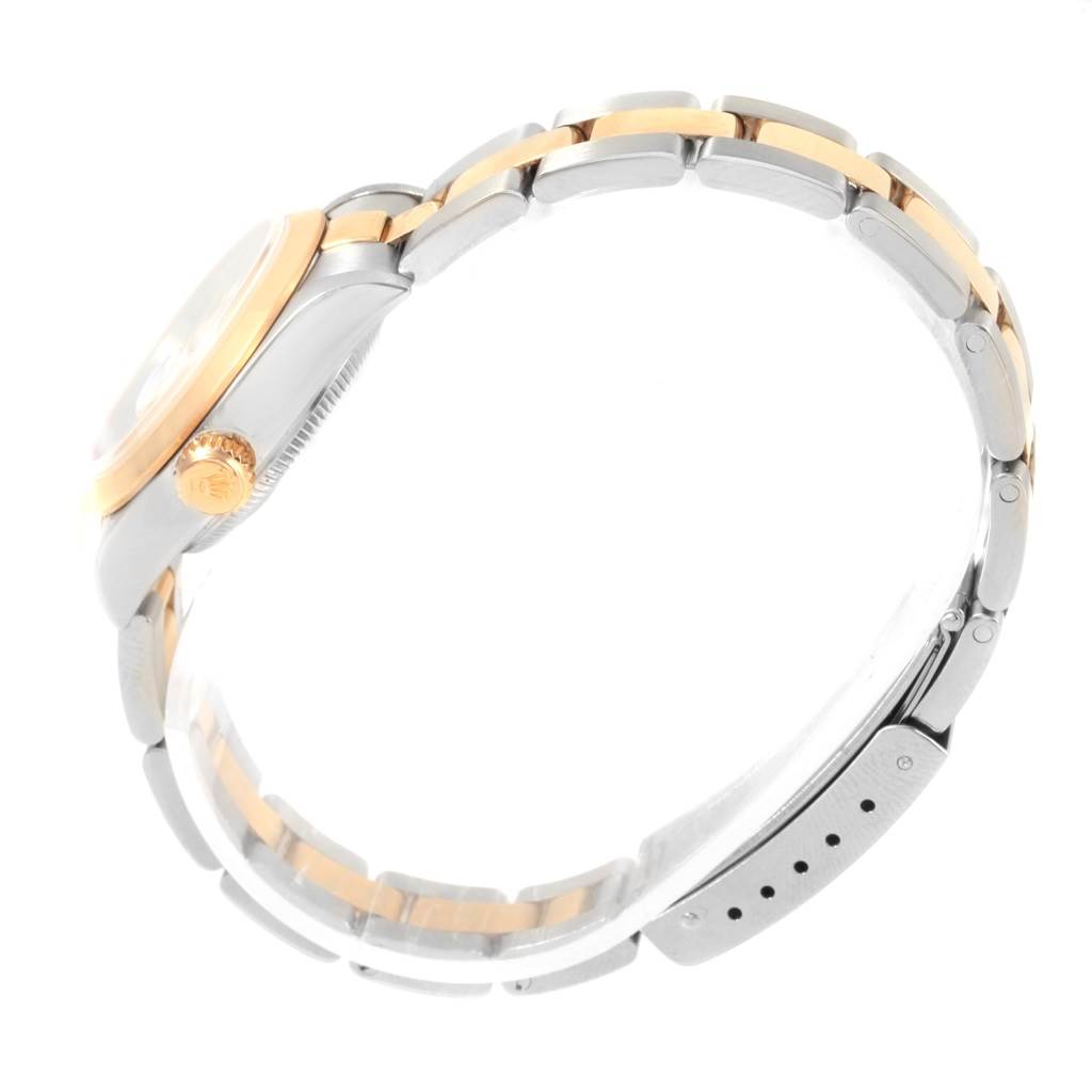 The Rolex Datejust 79163 Women's Steel and Gold (two tone) White Dial 79163 Women's Steel and Gold (two tone) White Dial watch is shown from the side, featuring the crown, case, and part of the bracelet.