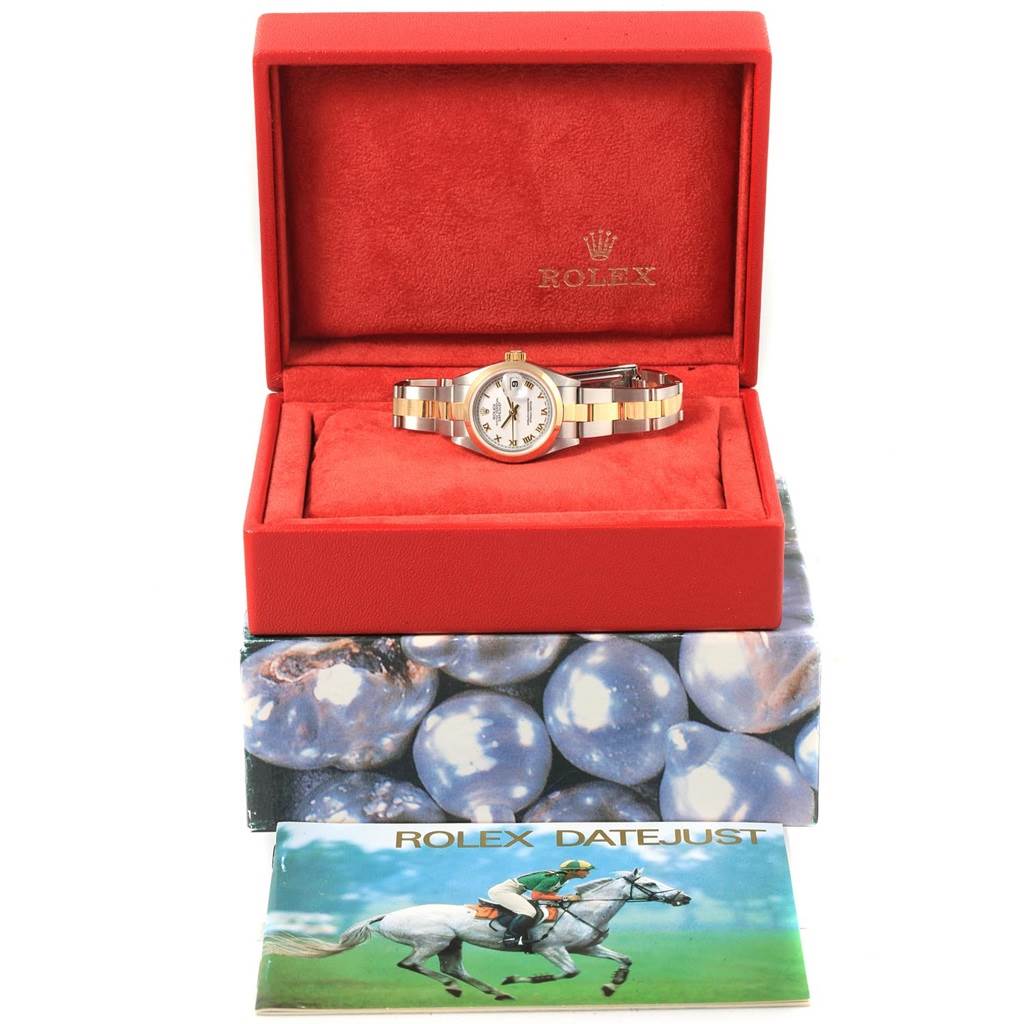 The Rolex Datejust 79163 Women's Steel and Gold (two tone) White Dial 79163 Women's Steel and Gold (two tone) White Dial watch is displayed front-facing in an open red box, accompanied by its brochure.