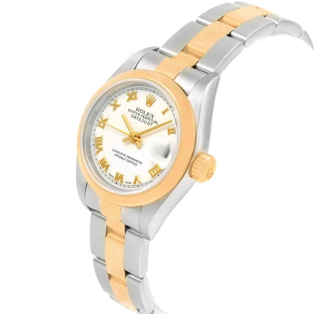 This image shows a Rolex Datejust 79163 Women's Steel and Gold (two tone) White Dial 79163 Women's Steel and Gold (two tone) White Dial watch featuring a two-tone metal bracelet, gold bezel, and dial with Roman numerals, viewed from an upper side angle.