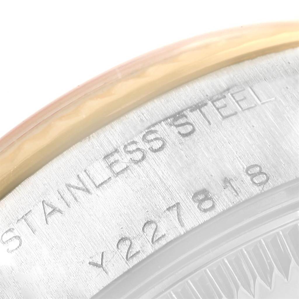 This close-up image of a Rolex Datejust 79173 Women's Steel and Gold (two tone) Champagne Dial 79173 Women's Steel and Gold (two tone) Champagne Dial watch shows the engraved "STAINLESS STEEL" text and part of the serial number.