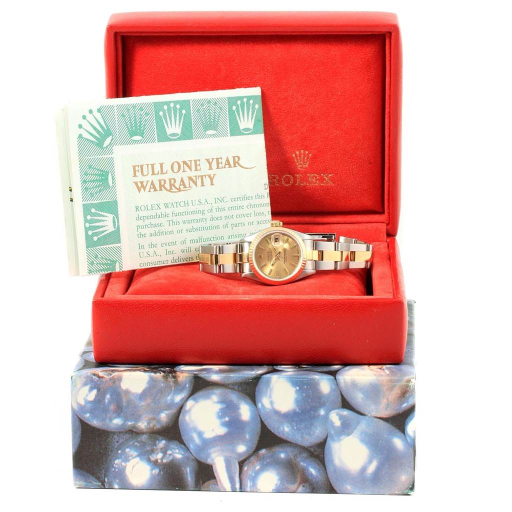 The Rolex Datejust 69173 Women
s Stainless Steel Champagne Dial 69173 Women
s Stainless Steel Champagne Dial watch is shown from the front inside its red box, accompanied by a warranty card.