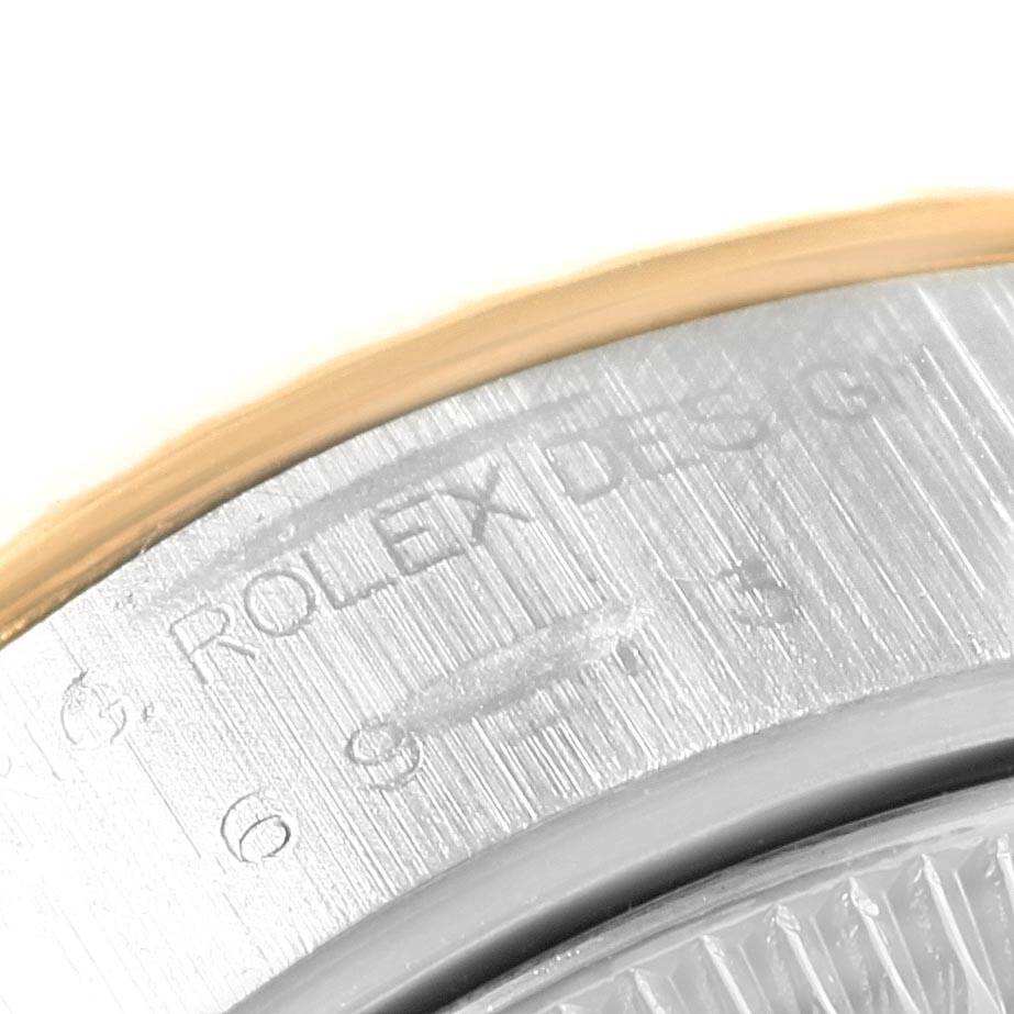 The image shows a close-up of the engraved details on the metal casing of a Rolex Datejust 69173 Women
s Stainless Steel Champagne Dial 69173 Women
s Stainless Steel Champagne Dial watch.