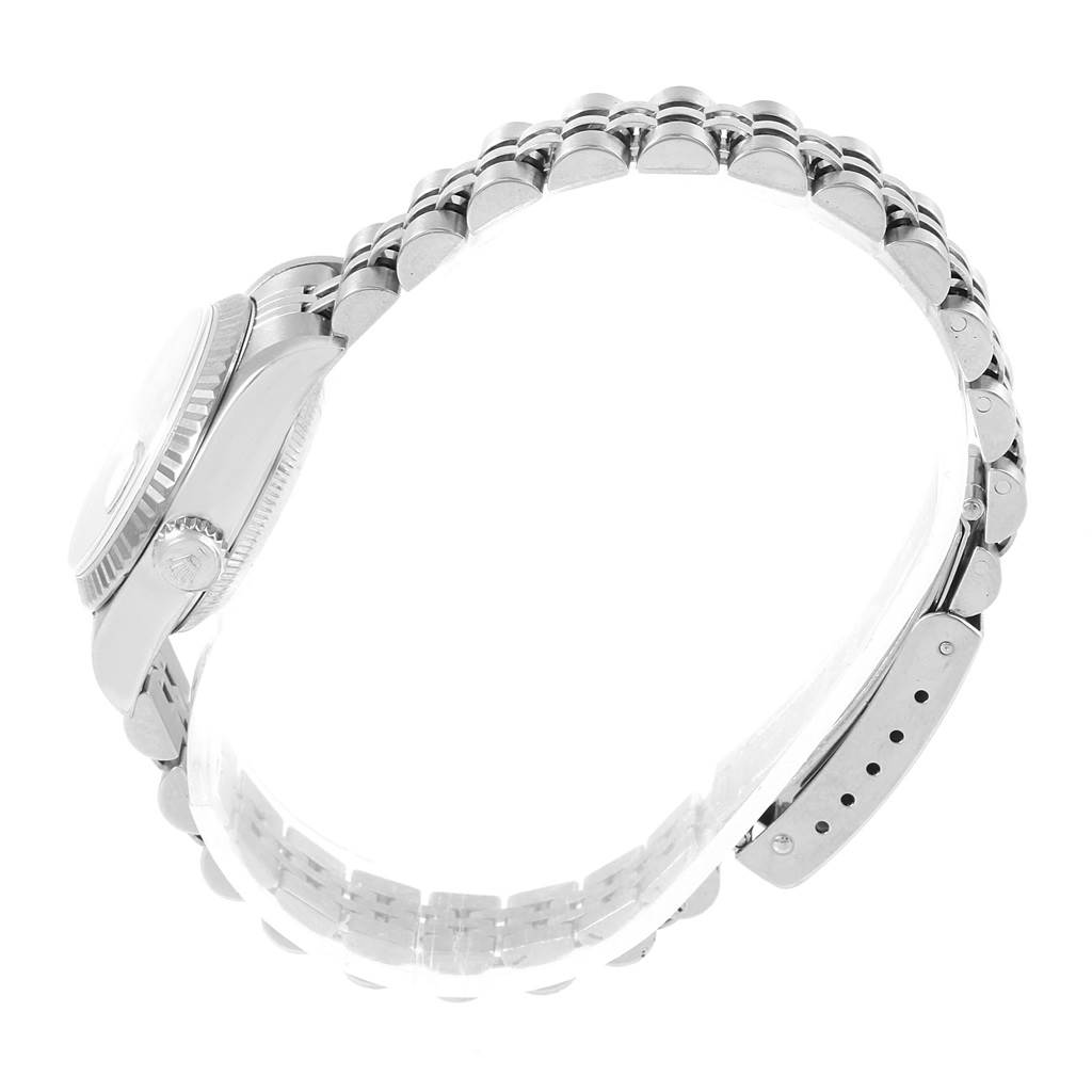 This side view image of the Rolex Datejust 79174 Women
s Stainless Steel Silver Dial 79174 Women
s Stainless Steel Silver Dial watch shows the crown, case, and part of the bracelet.