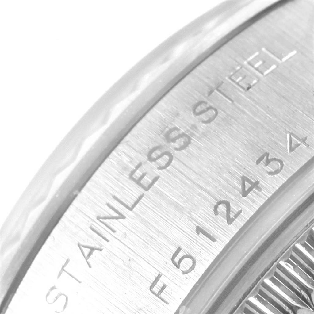 This close-up image shows part of the stainless steel casing and serial number of a Rolex Datejust 79174 Women
s Stainless Steel Silver Dial 79174 Women
s Stainless Steel Silver Dial watch.