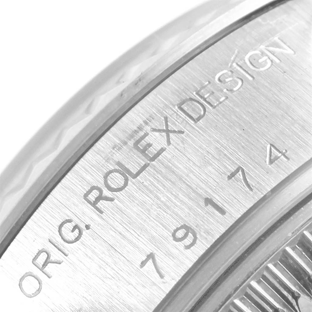 This close-up image shows the engraved reference number and design text on the case of a Rolex Datejust 79174 Women
s Stainless Steel Silver Dial 79174 Women
s Stainless Steel Silver Dial watch.
