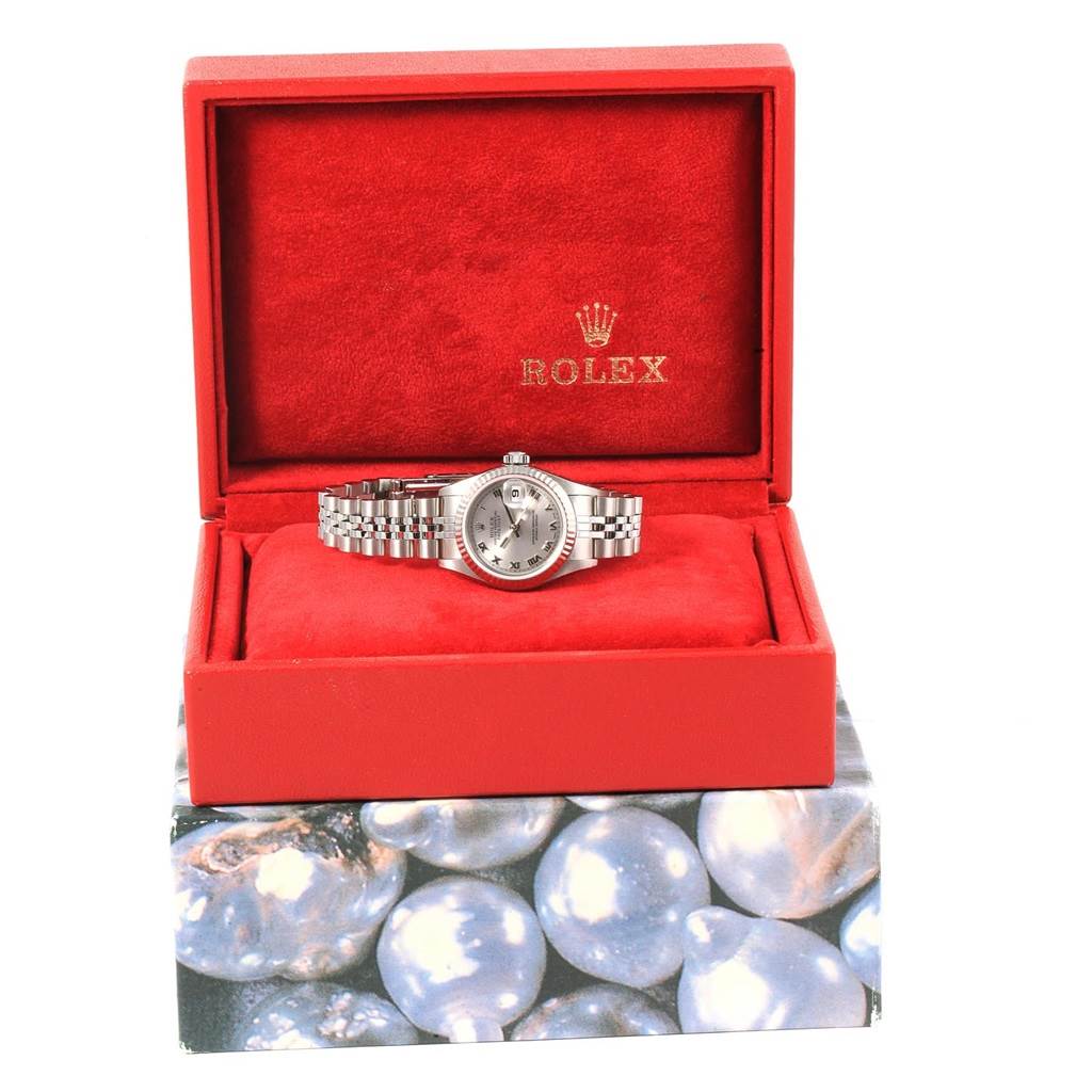 The Rolex Datejust 79174 Women
s Stainless Steel Silver Dial 79174 Women
s Stainless Steel Silver Dial watch is shown from a top angle, displayed in an open red box with a visible bracelet and dial.