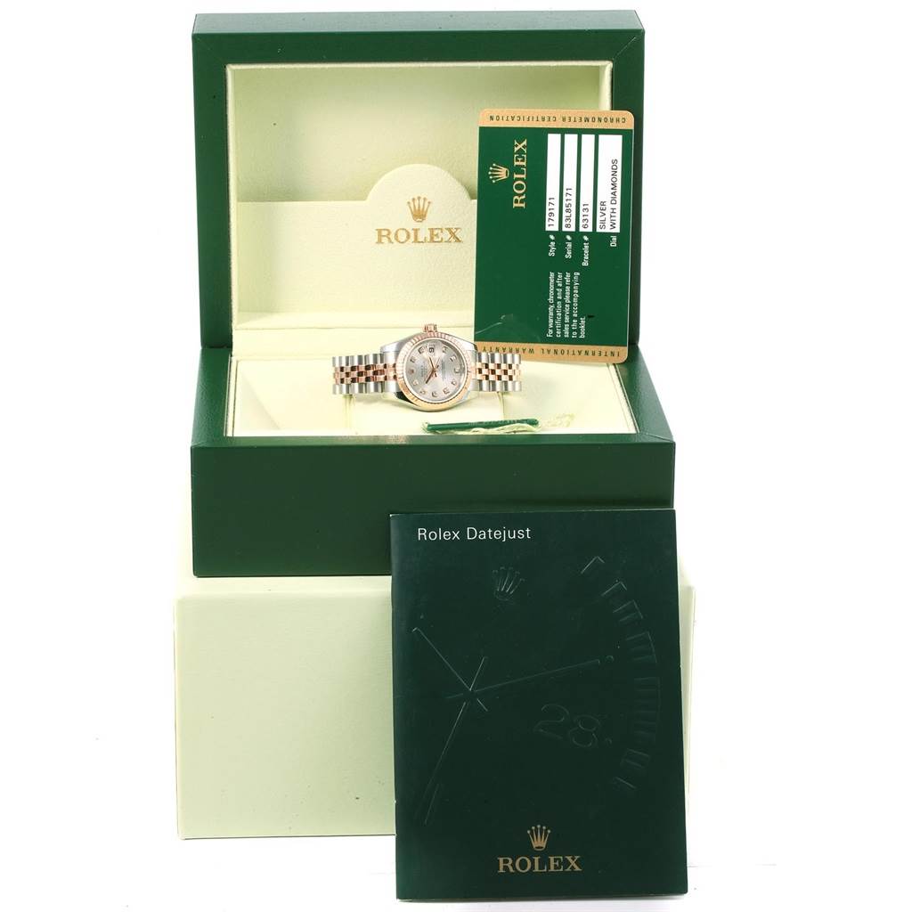 The image shows a Rolex Datejust 179171 Women
s Steel and Gold (two tone) Silver Dial 179171 Women
s Steel and Gold (two tone) Silver Dial watch set inside its green box, along with the guarantee card and user manual.