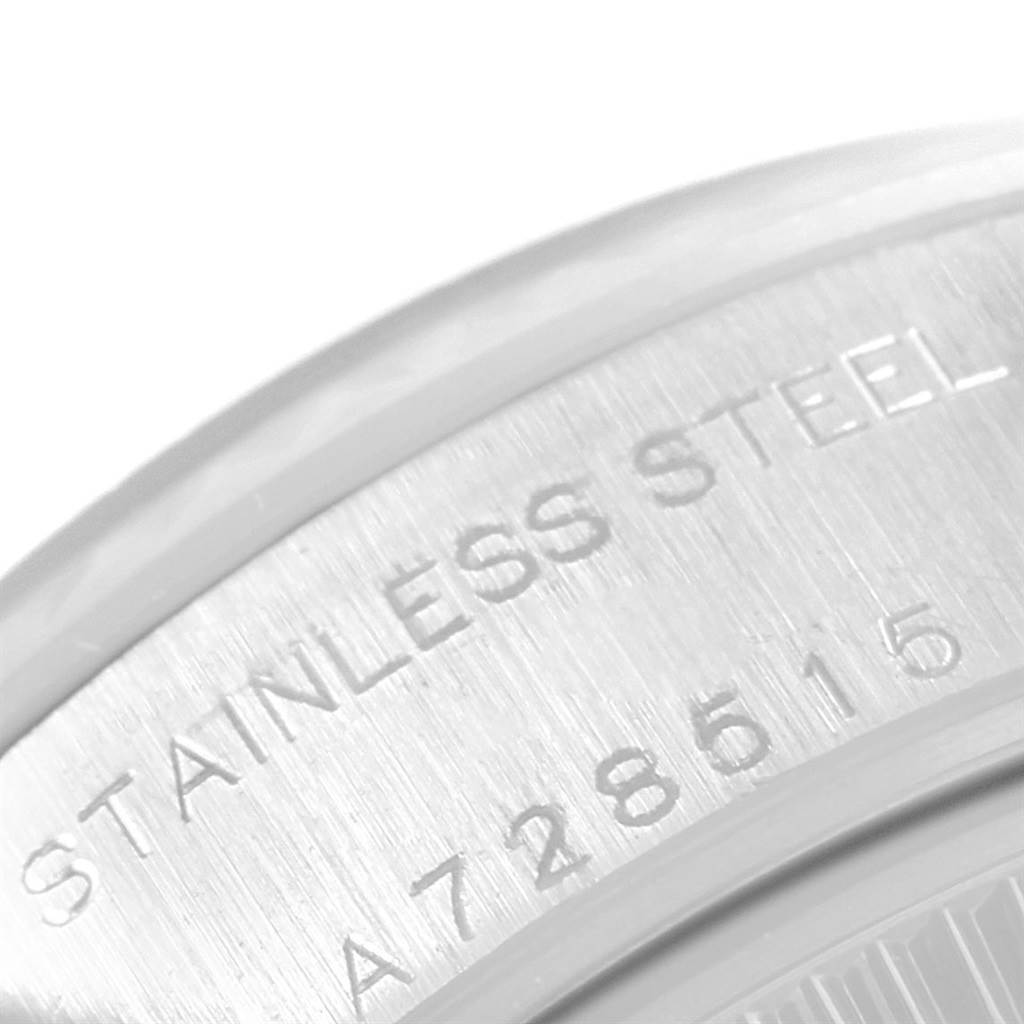 This close-up image shows the stainless steel engraving and part of the serial number on the case back of a Rolex Datejust 79174 Women's Stainless Steel Black Dial 79174 Women's Stainless Steel Black Dial watch.