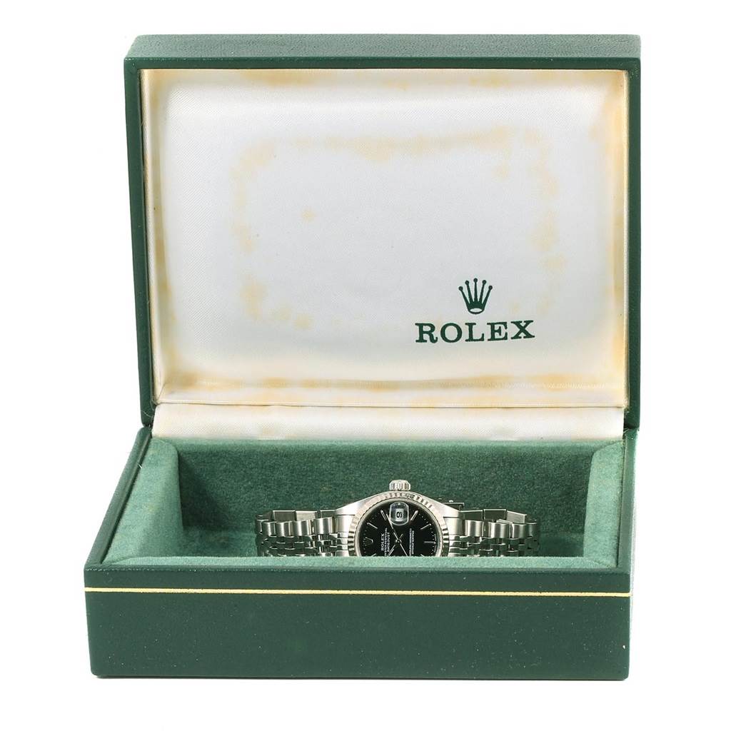 The image shows a Rolex Datejust 79174 Women's Stainless Steel Black Dial 79174 Women's Stainless Steel Black Dial watch placed in an open green Rolex box, viewed from a slightly elevated front angle.