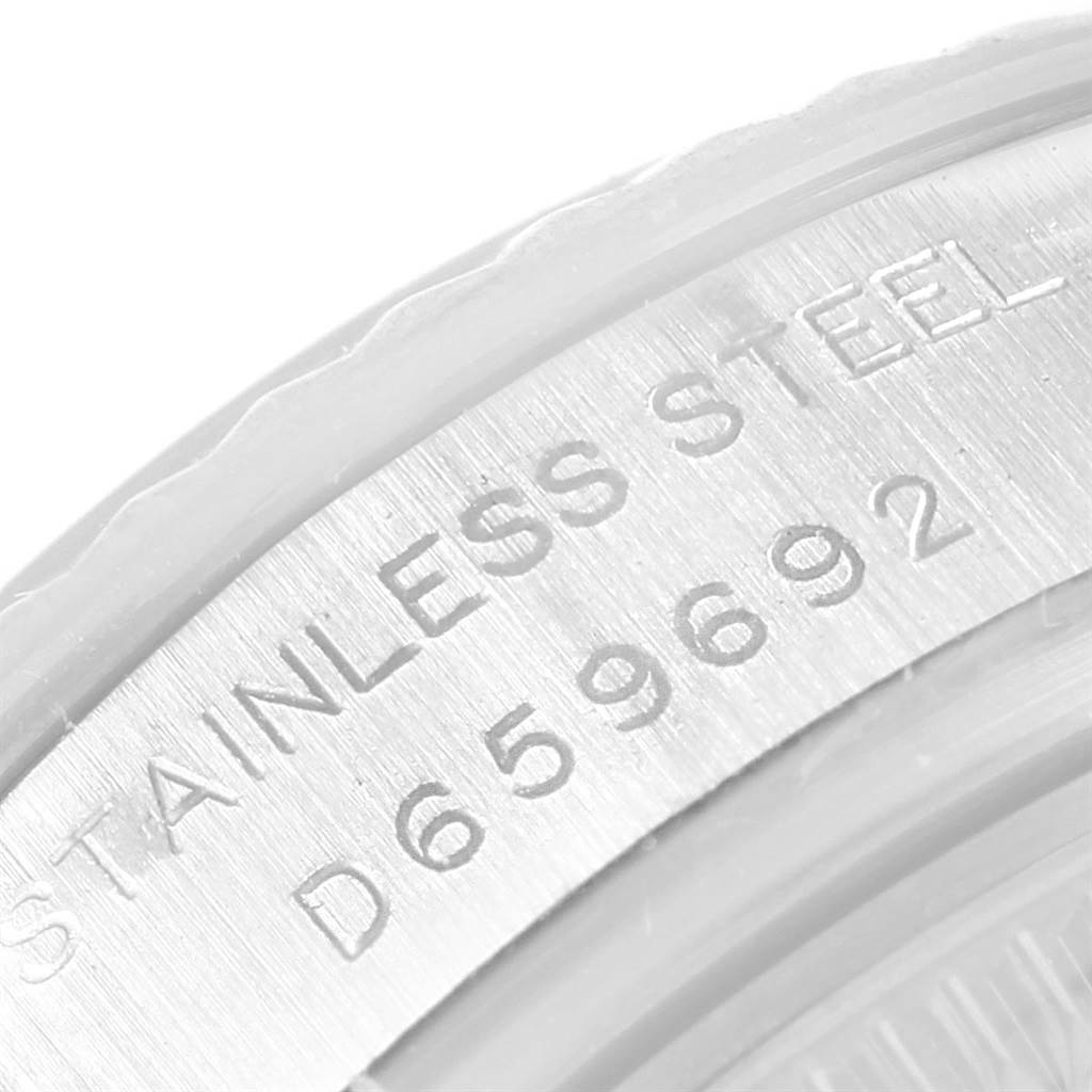 This image shows a close-up of the engraved serial number and "STAINLESS STEEL" text on a Rolex Datejust 179174 Women
s Stainless Steel Mother of Pearl Dial 179174 Women
s Stainless Steel Mother of Pearl Dial watch.