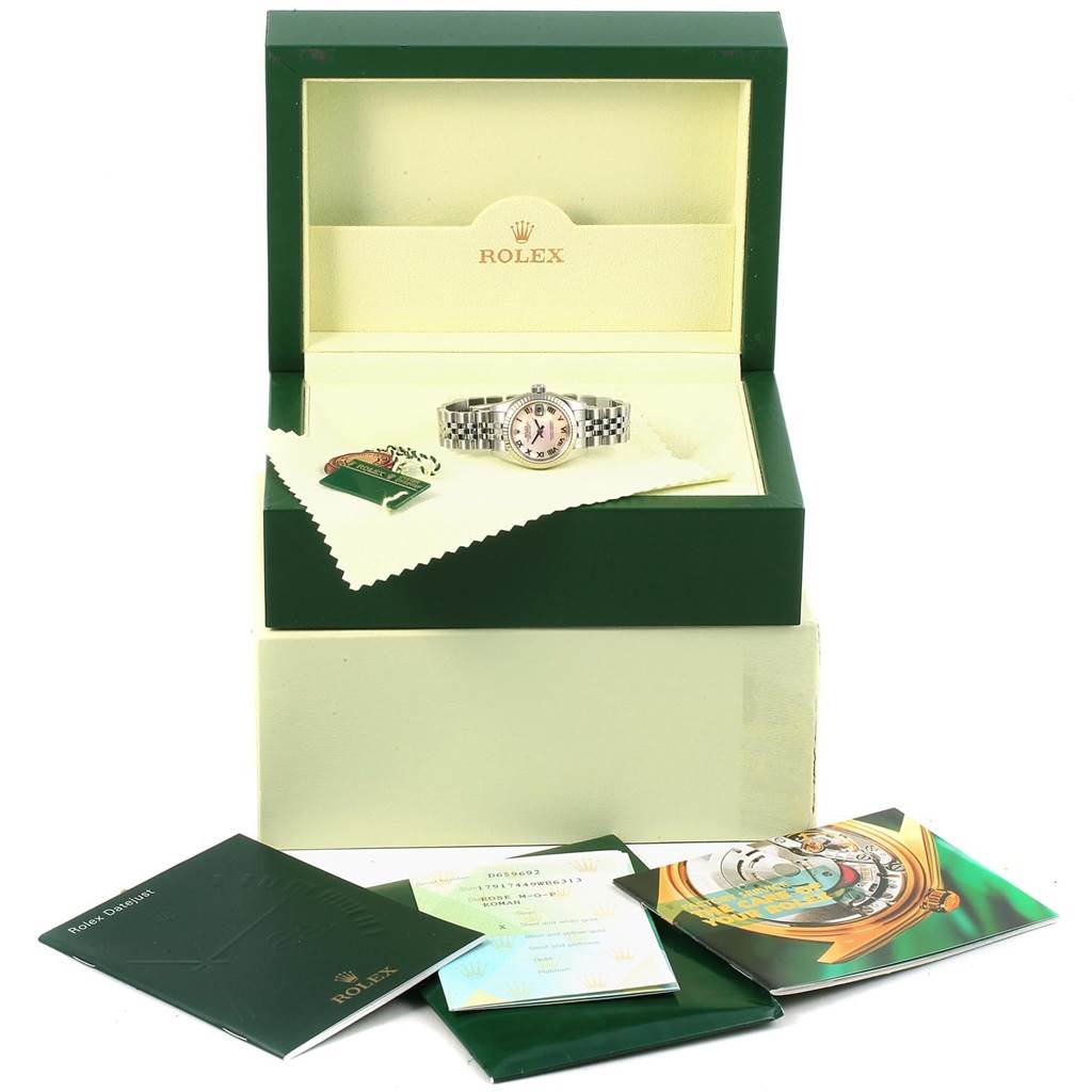 The Rolex Datejust 179174 Women
s Stainless Steel Mother of Pearl Dial 179174 Women
s Stainless Steel Mother of Pearl Dial watch is shown in its open box at an eye-level angle with accompanying booklets and tags.