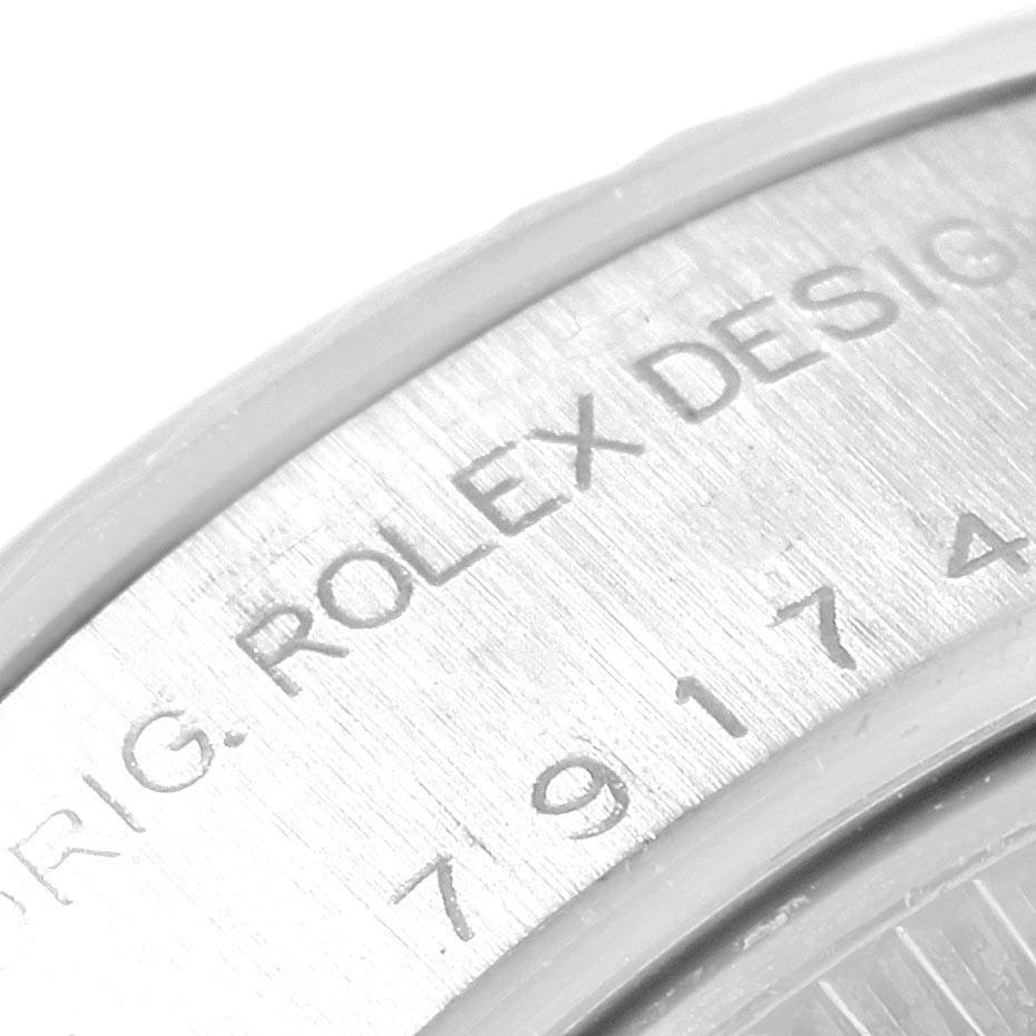 The image shows a close-up angle of the casing exterior with engravings on a Rolex Datejust 79174 Women
s Stainless Steel White Dial 79174 Women
s Stainless Steel White Dial watch.