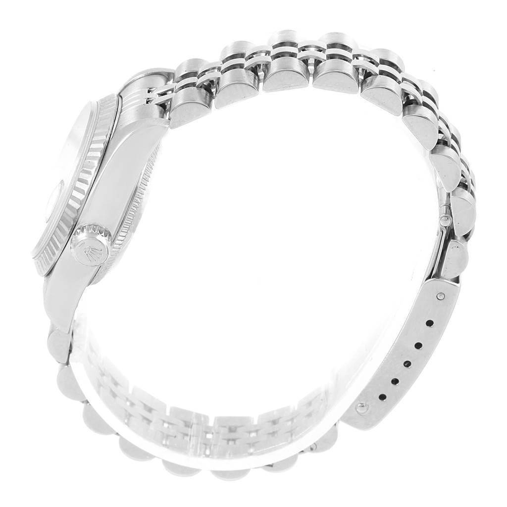 This image shows a side angle of a Rolex Datejust 79174 Women
s Stainless Steel White Dial 79174 Women
s Stainless Steel White Dial watch, highlighting the crown, case, and part of the metal bracelet.