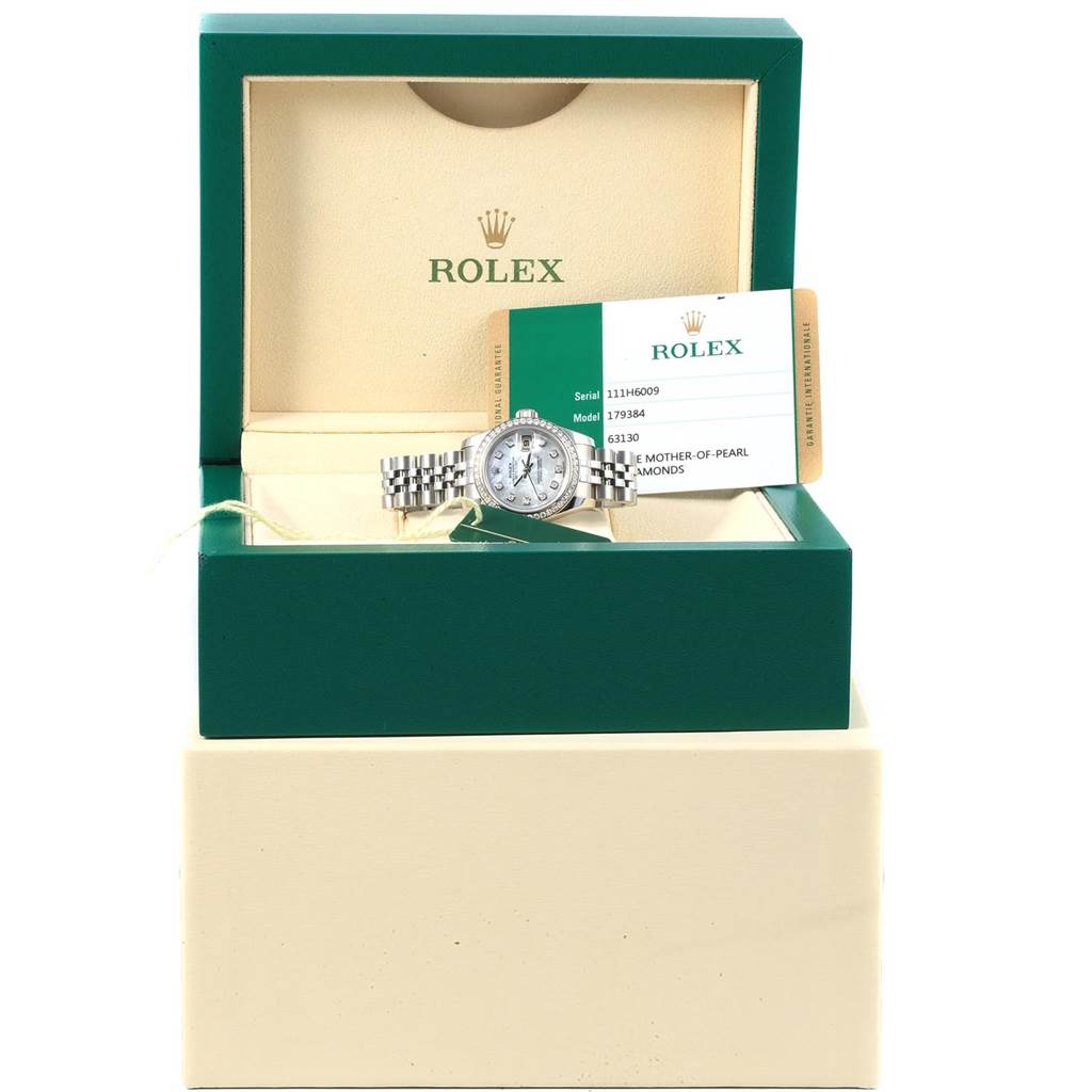 The image shows a front view of a Rolex Datejust 179384 Women's Stainless Steel Mother of Pearl Dial 179384 Women's Stainless Steel Mother of Pearl Dial watch in an open green box with a warranty card and manual.