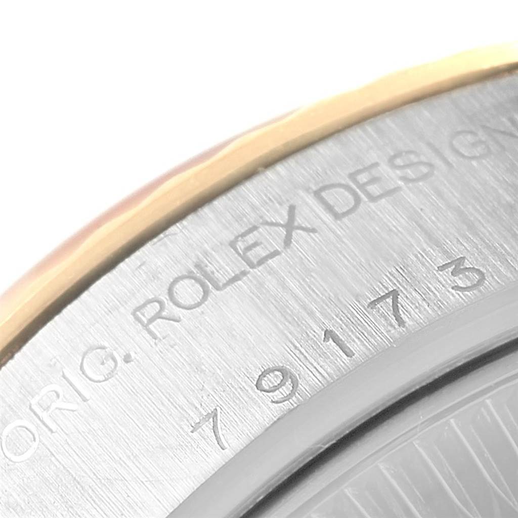 This image shows a close-up of the case back and serial number of the Rolex Datejust 79173 Women's Steel and Gold (two tone) Black Dial 79173 Women's Steel and Gold (two tone) Black Dial watch.
