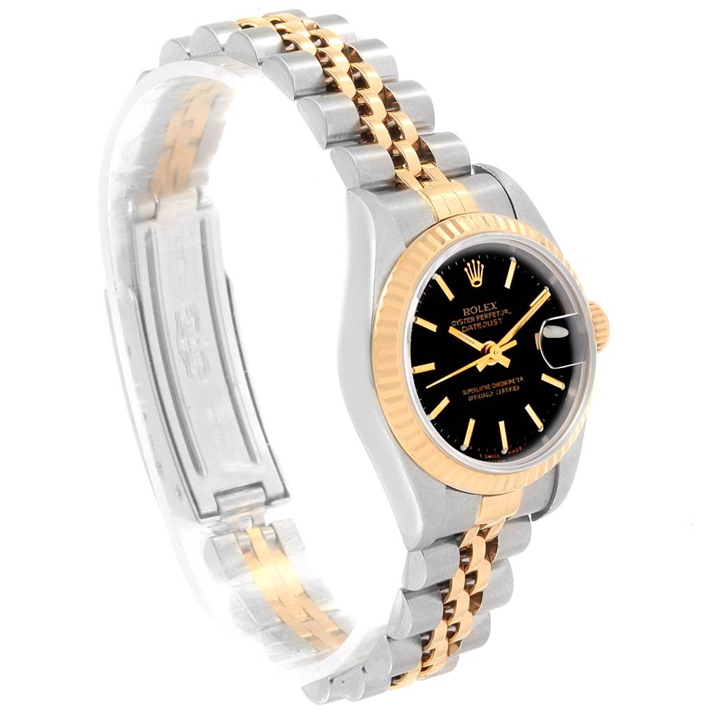 The image shows a Rolex Datejust 79173 Women's Steel and Gold (two tone) Black Dial 79173 Women's Steel and Gold (two tone) Black Dial watch from an angled side view, displaying its two-tone bracelet, black dial, and date feature.