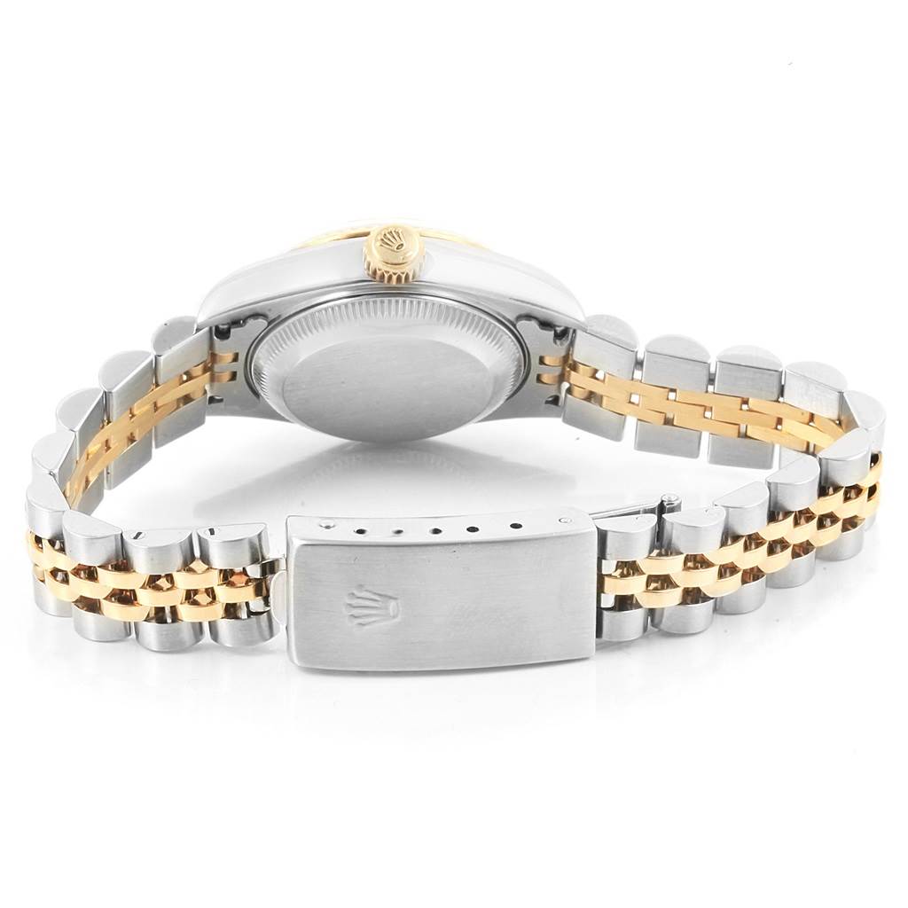 The image shows the back view of a Rolex Datejust 79173 Women's Steel and Gold (two tone) Black Dial 79173 Women's Steel and Gold (two tone) Black Dial watch, highlighting its case, crown, and metal bracelet.