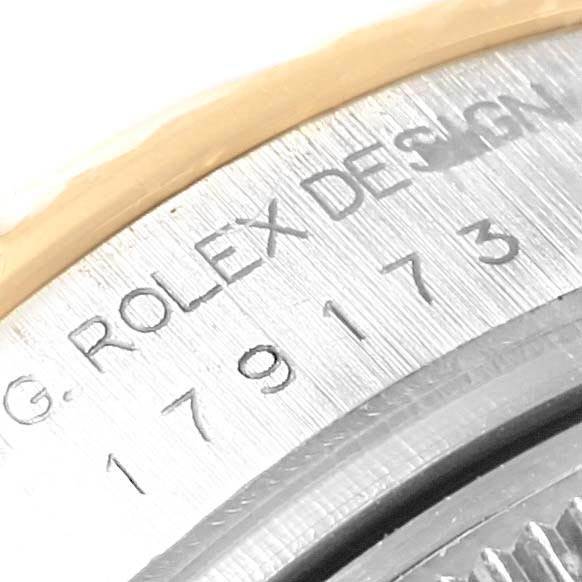 The image shows a close-up of the Rolex Datejust 179173 Women's Steel and Gold (two tone) White Dial 179173 Women's Steel and Gold (two tone) White Dial model's engraved casing, highlighting the serial number and "Rolex Design" inscription.