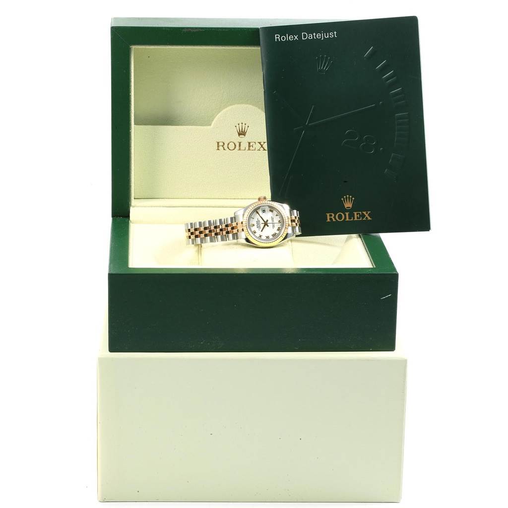 The image shows a Rolex Datejust 179173 Women's Steel and Gold (two tone) White Dial 179173 Women's Steel and Gold (two tone) White Dial watch in a green Rolex box with a matching booklet in the background.