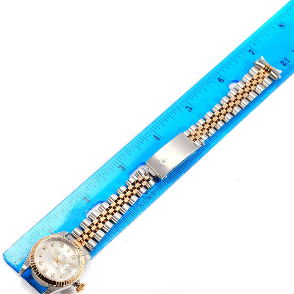 The image shows a Rolex Datejust 79173 Women's Stainless Steel Silver Dial 79173 Women's Stainless Steel Silver Dial watch, displayed flat alongside a ruler, revealing the dial and bracelet.