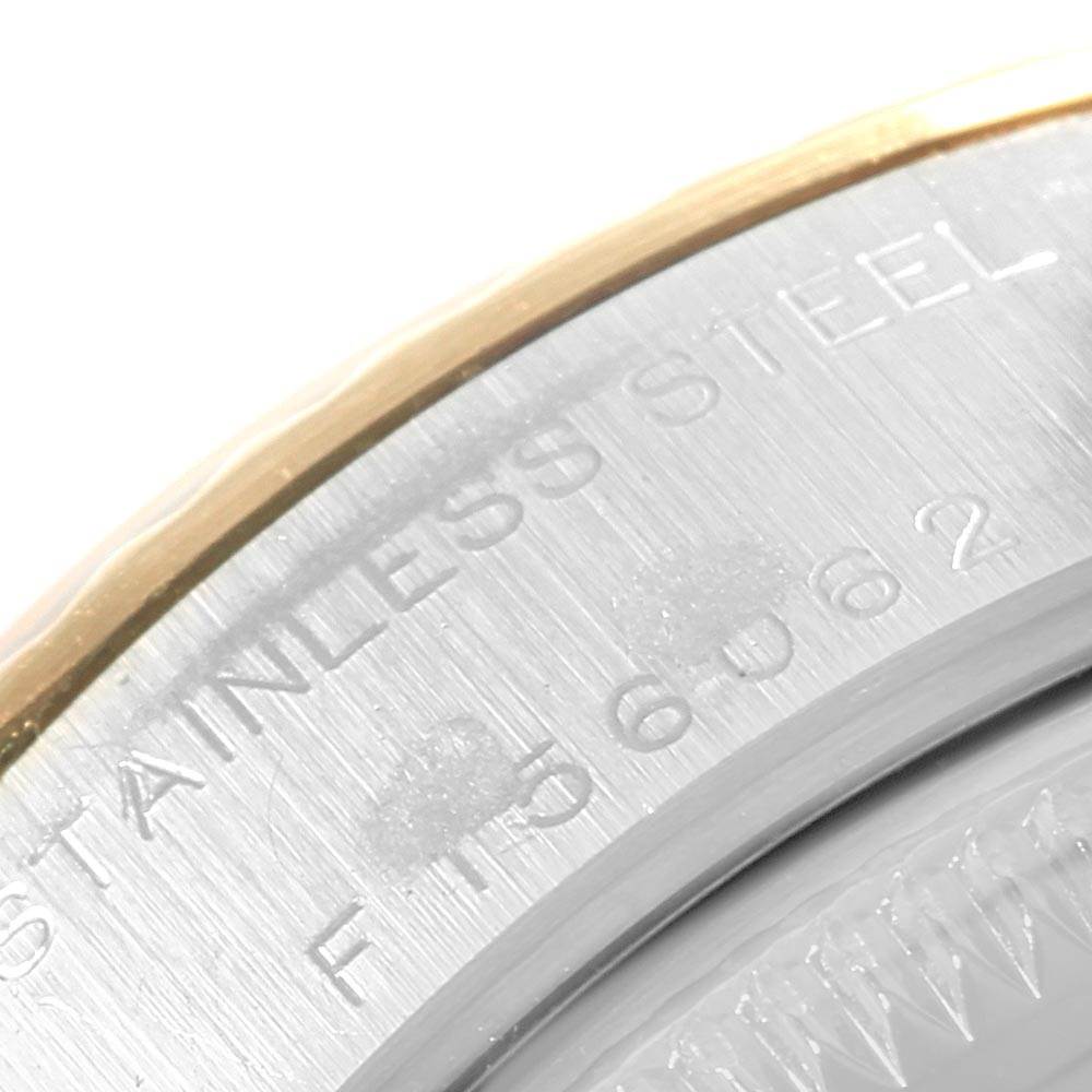 The image shows a close-up view of the stainless steel case back and part of the gold bezel of a Rolex Datejust 79173 Women's Stainless Steel Silver Dial 79173 Women's Stainless Steel Silver Dial watch.