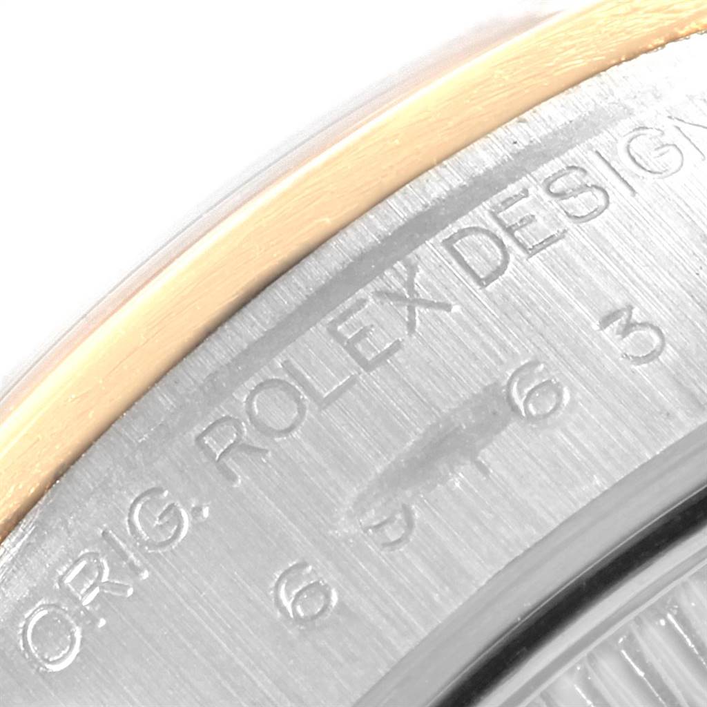 The image shows a close-up of the exterior case back of the Rolex Datejust 69163 Women's Steel and Gold (two tone) Grey Dial 69163 Women's Steel and Gold (two tone) Grey Dial watch, highlighting the engravings and part of the bezel.