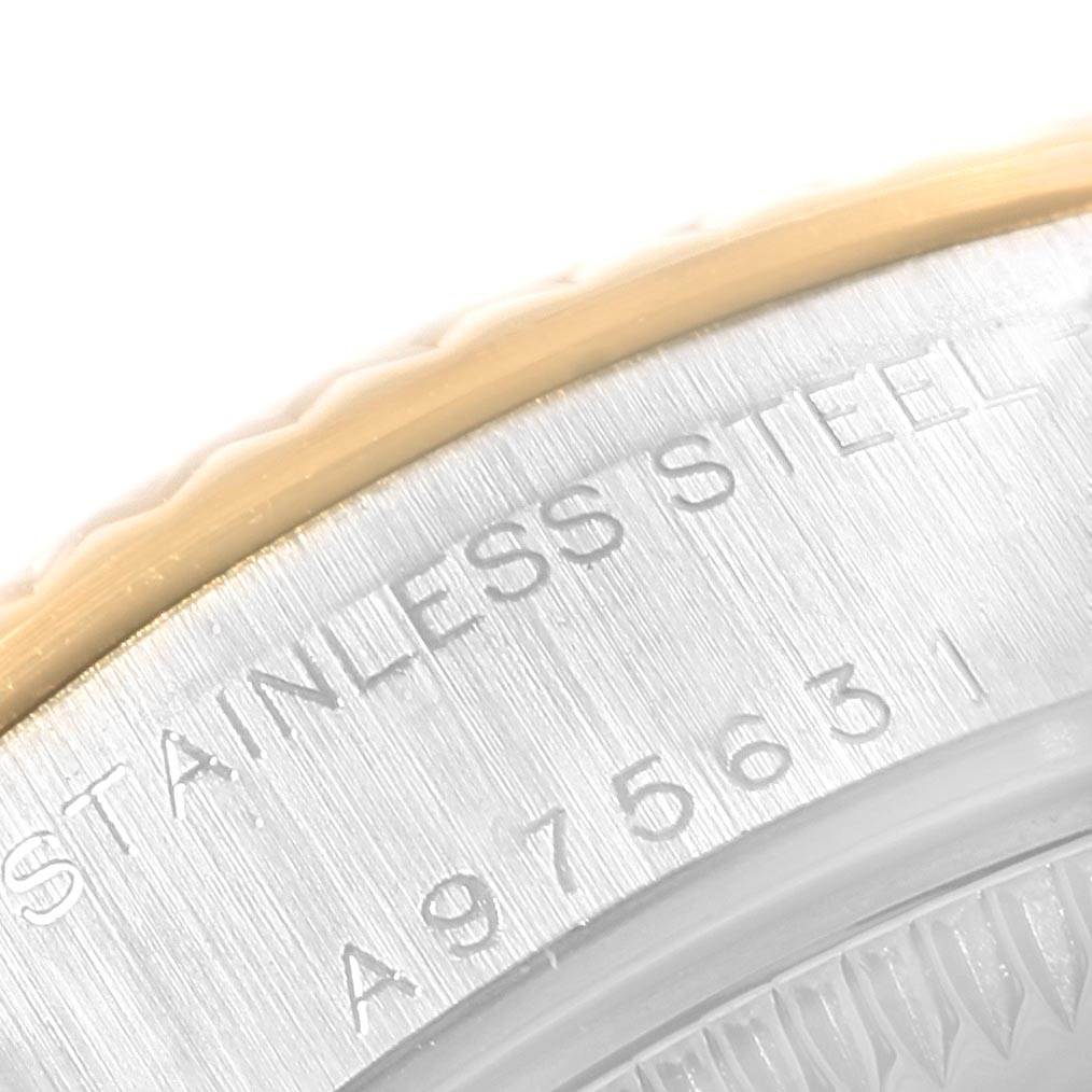 The image shows a close-up of the bezel and stainless steel caseback with engravings on a Rolex Datejust 79173 Women's Stainless Steel Black Dial 79173 Women's Stainless Steel Black Dial watch.