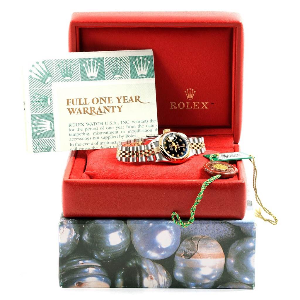 The image shows a Rolex Datejust 79173 Women's Stainless Steel Black Dial 79173 Women's Stainless Steel Black Dial watch in its open red box, with a warranty card and tags.