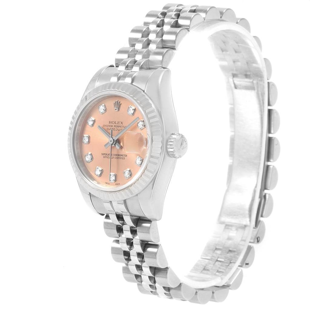 The image shows a side view of a Rolex Datejust 179174 Women
s Stainless Steel Pink Dial 179174 Women
s Stainless Steel Pink Dial watch, highlighting its pink face, diamond hour markers, and jubilee bracelet.